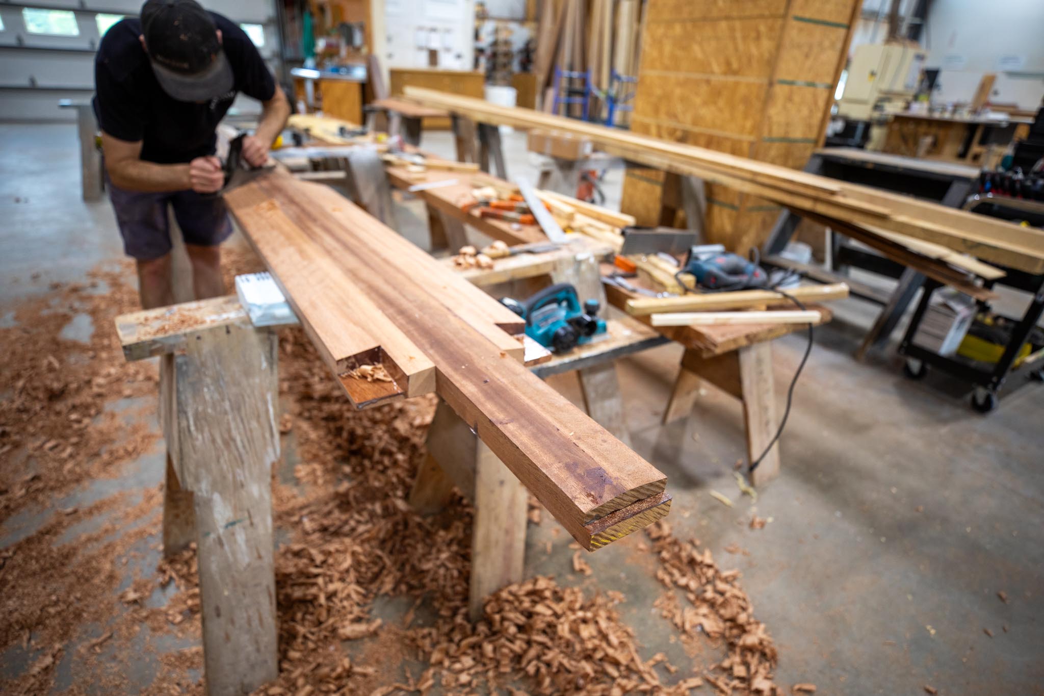 African mahogany being hand planed by the craftsmen at Van Dam.