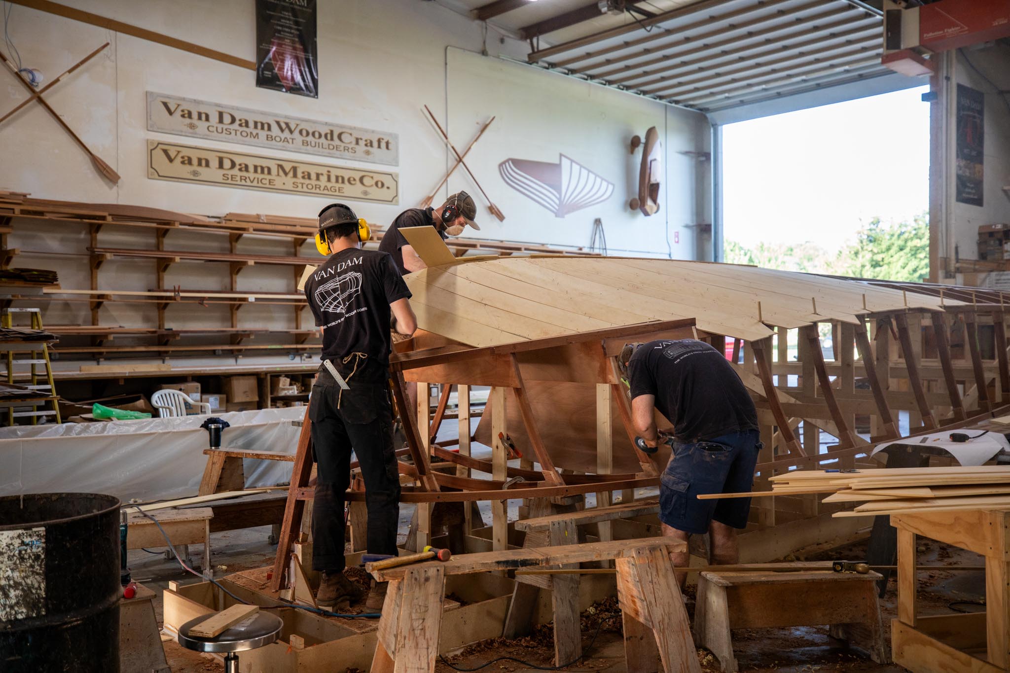 Craftspeople applying planking to Last Call